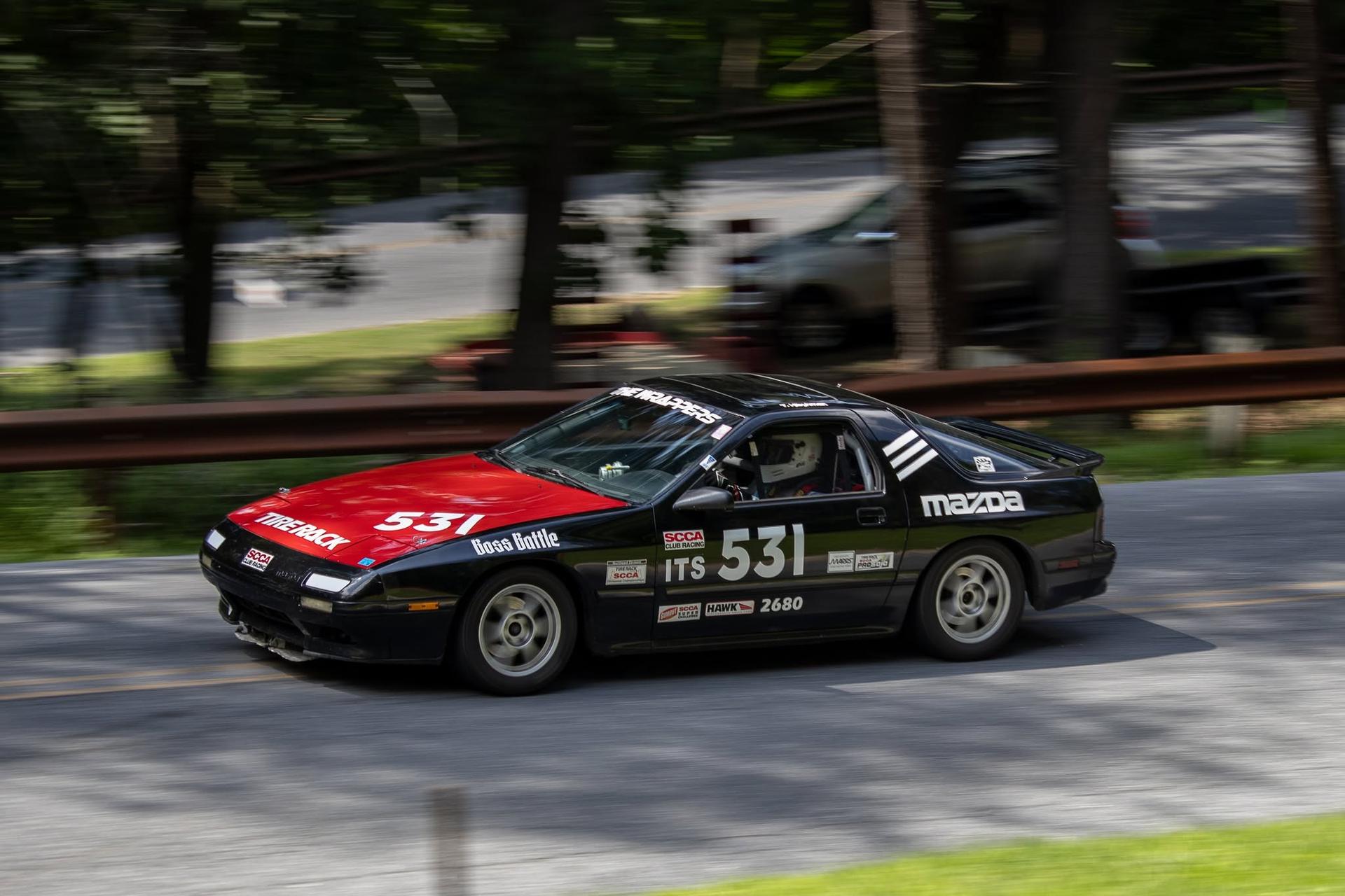 Tannon Hibshman driving his Mazda RX-7 up a hillclimb course